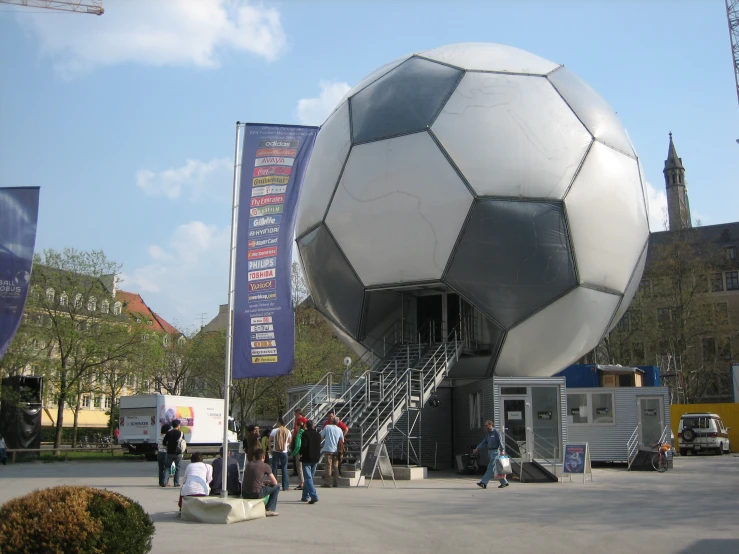 an oversized ball in front of a museum