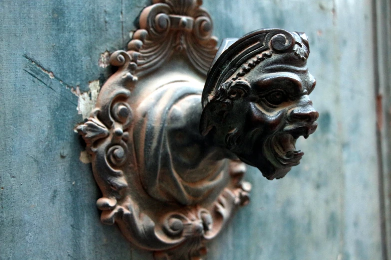 the door handle is ornately carved and has a head