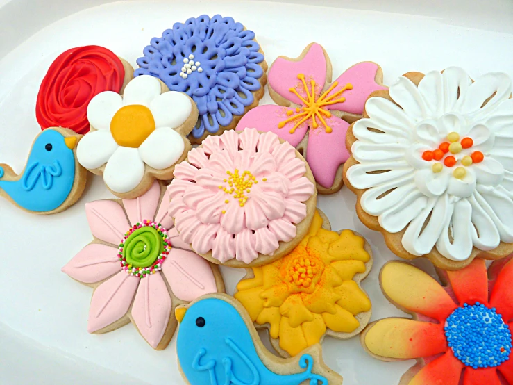 decorated cookies with different colors and designs on a plate