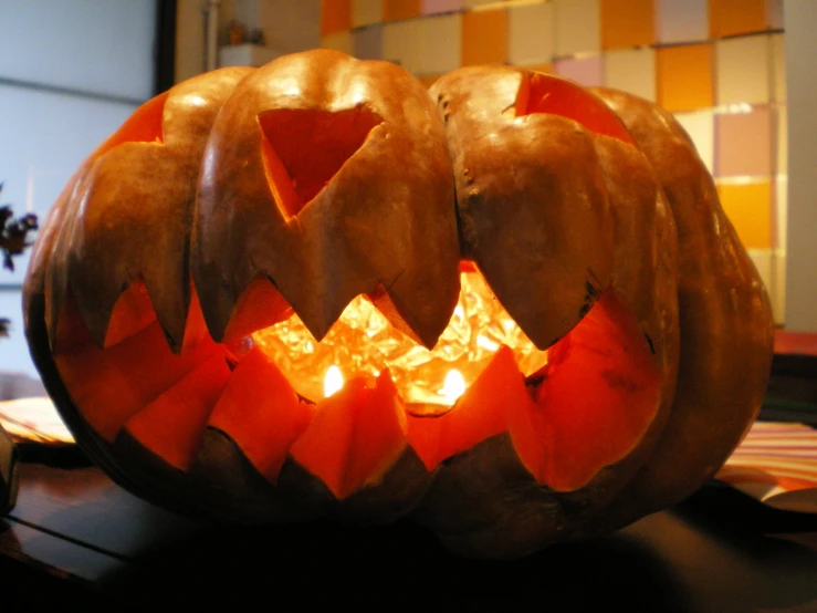 a carved pumpkin sits on top of a table