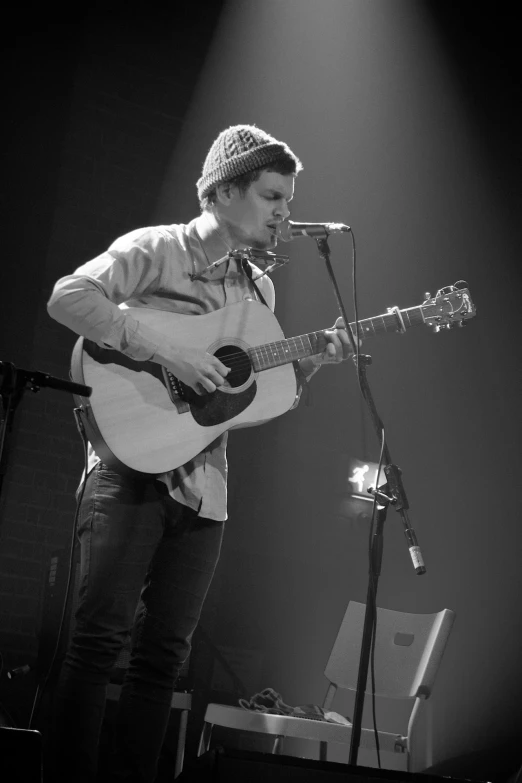 a man is playing the guitar at a concert