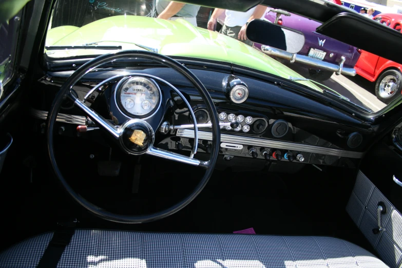 dashboard of automobile in urban scene with vintage car