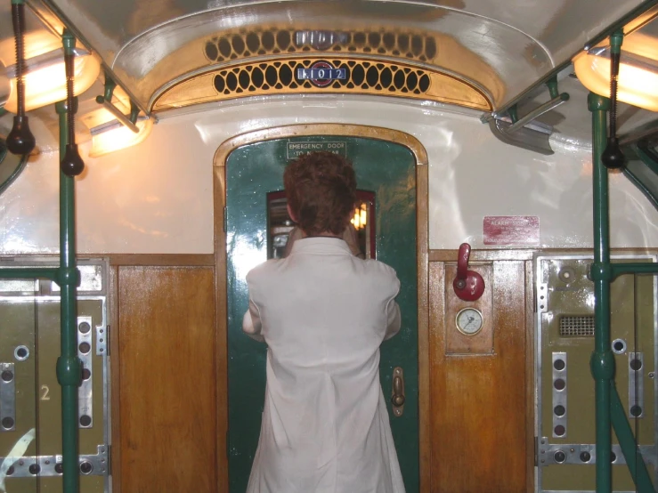 a person standing in front of a door on a bus