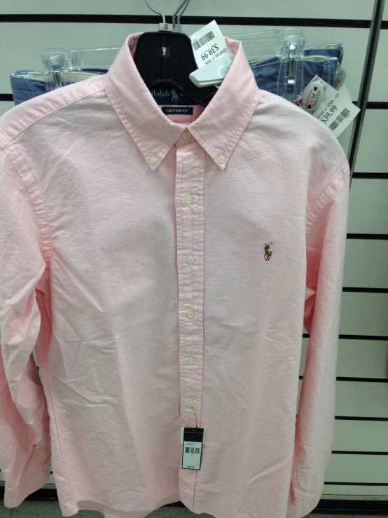 a pink shirt is hung on display