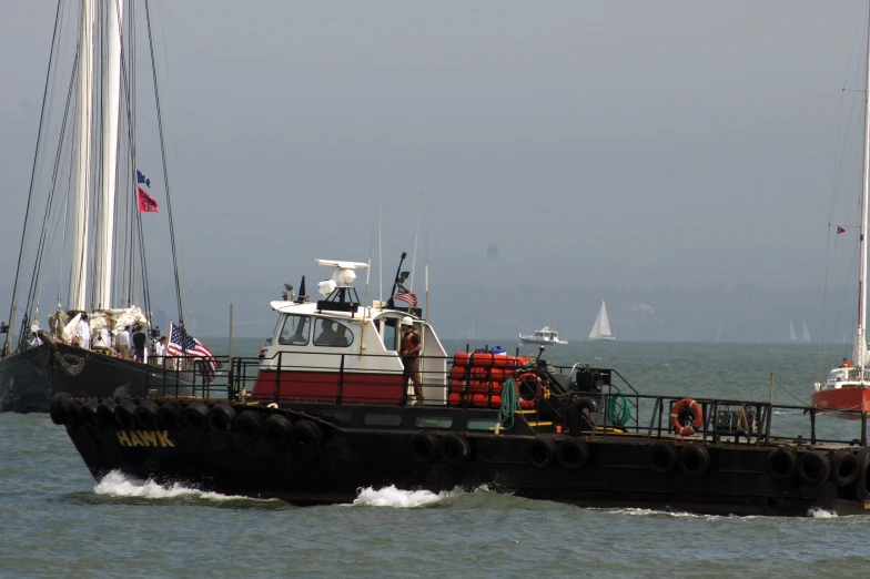 several people are standing on a black and white boat