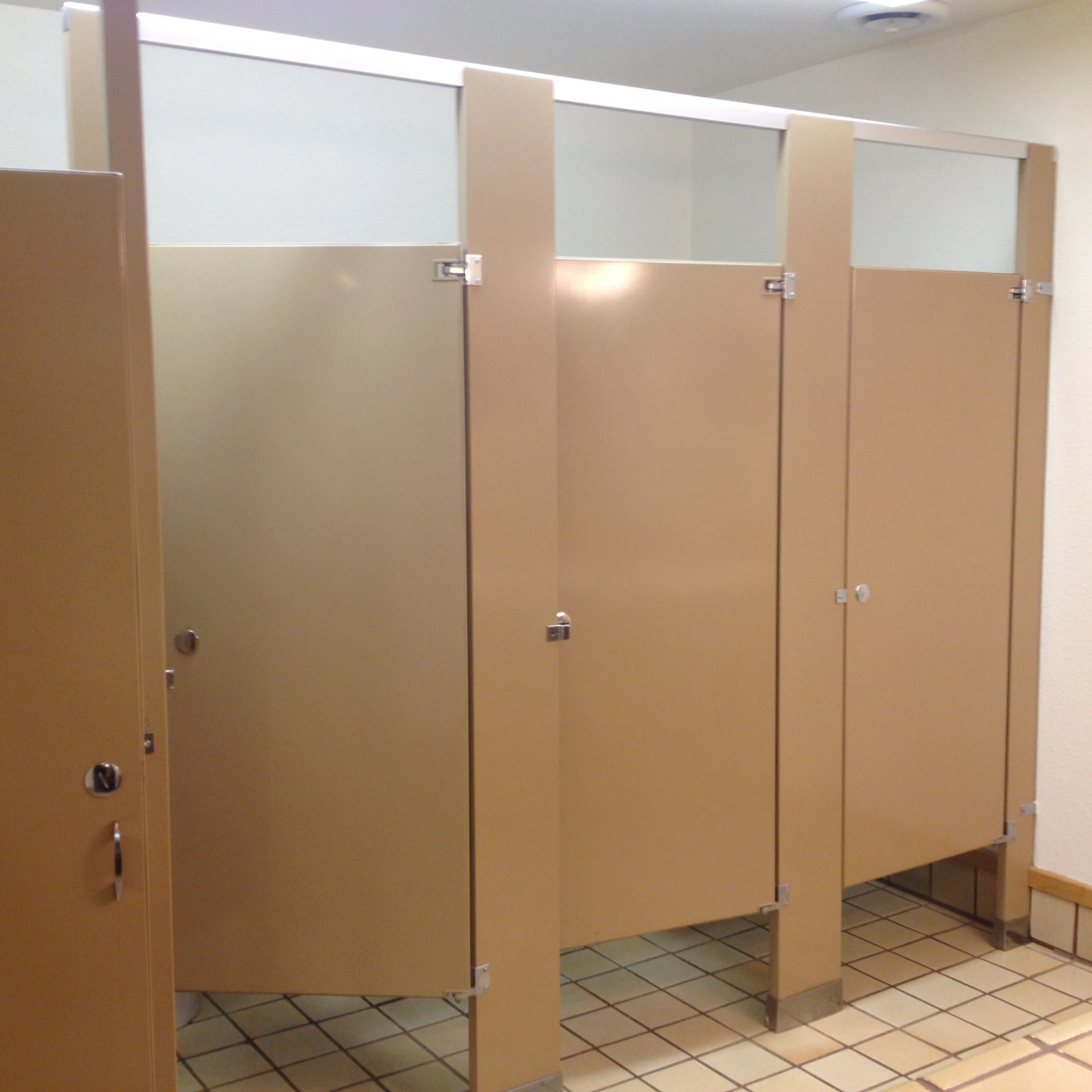 a bunch of restroom stalls in a building