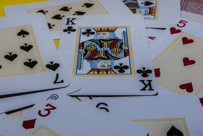 several poker cards are spread out on top of one another