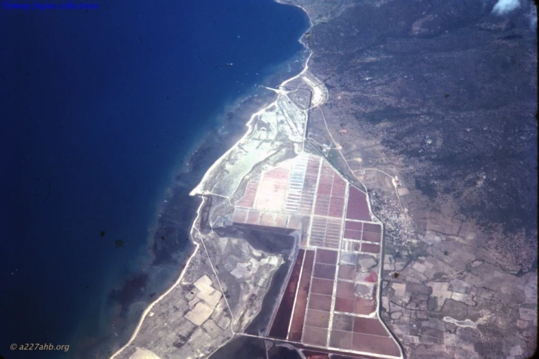 an aerial view shows the large buildings and mountains around a blue lake