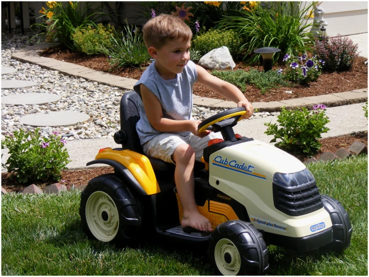 a  sits in a toy tractor