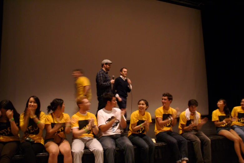 several people with a yellow shirt in a row