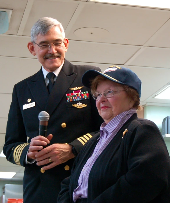 a man and woman in uniform, standing next to each other