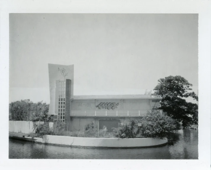 an old picture of the building on the water