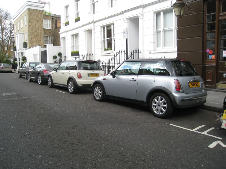 small cars line up on the street along the curb