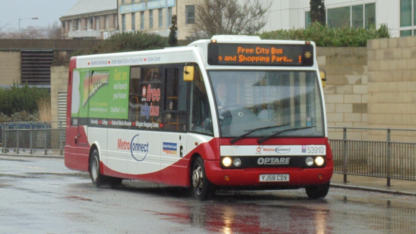 a bus is turning on the road in the rain