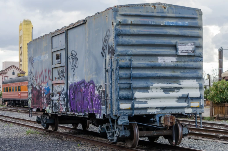 this freight train is covered in graffiti and has been tagged