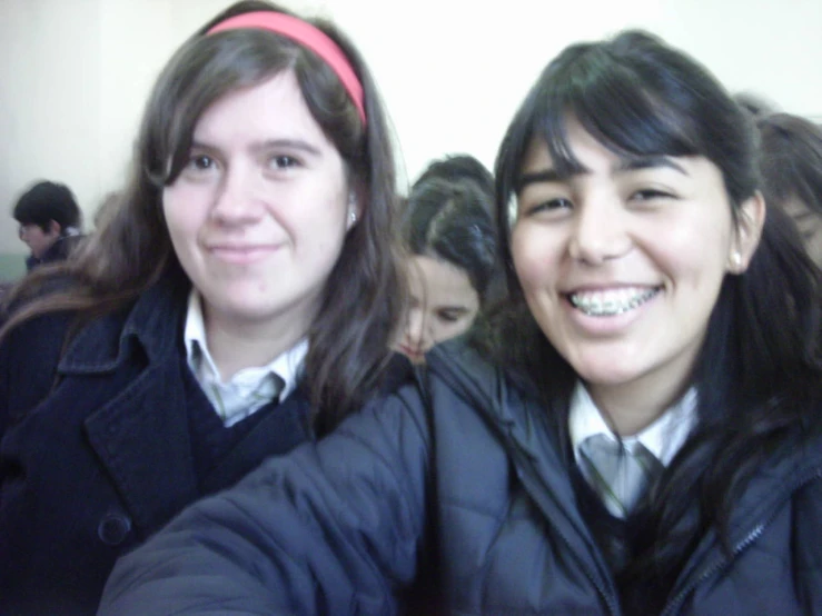 two young women taking a selfie while taking a selfie