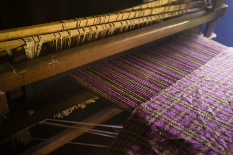 a loom weaving with wooden and colorful material