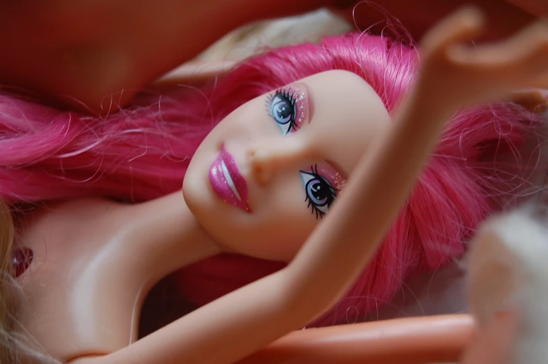 a red doll with big blue eyes and long red hair