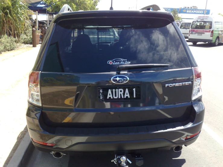 this is an image of the rear end of a silver suv