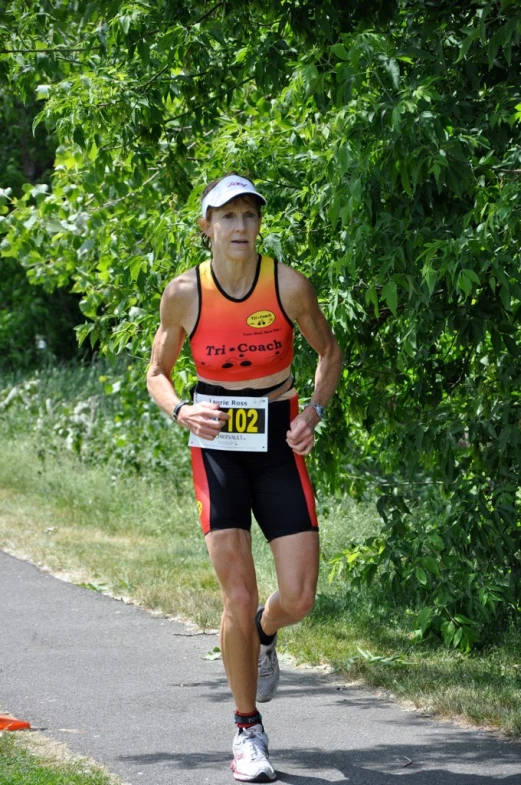 a man running down a path through trees