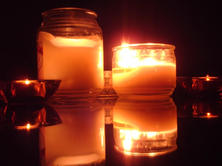 candle lit in jars filled with candles