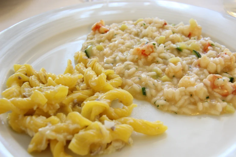 some pasta and shrimp are on a white plate