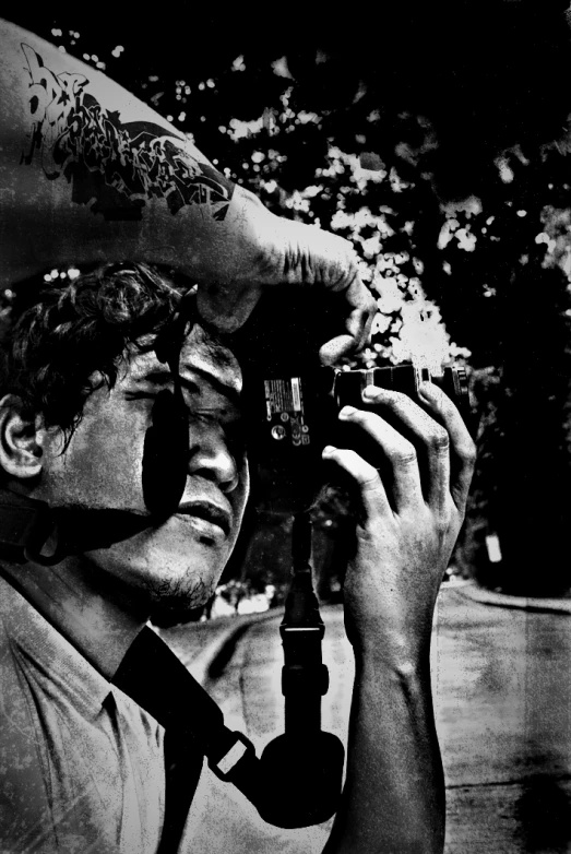a man is holding a camera and looking at the picture