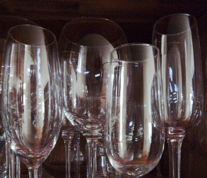 a number of wine glasses in close up with a black background