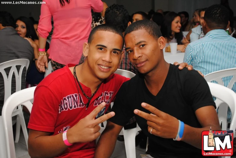 two males posing together for a picture at a social event