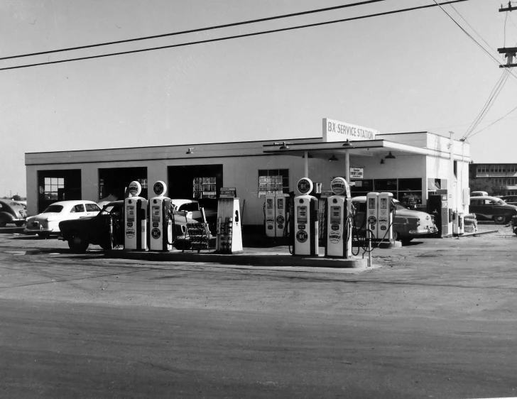 there are cars parked in front of a gas station