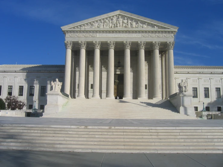 a court with steps leading to it and a statue on top of a podium