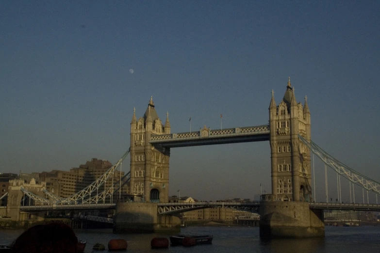 a bridge in the evening light with people standing on either side