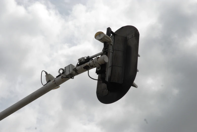 a military aircraft on a lift under a cloudy sky