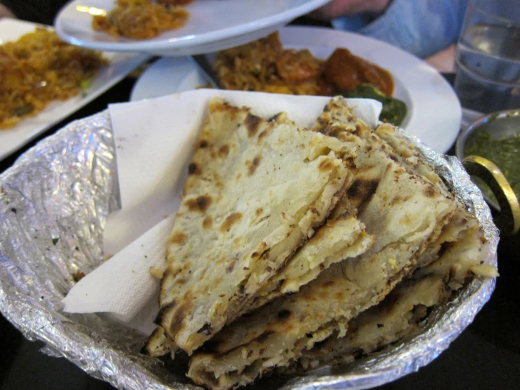 several pieces of food are arranged on paper plates