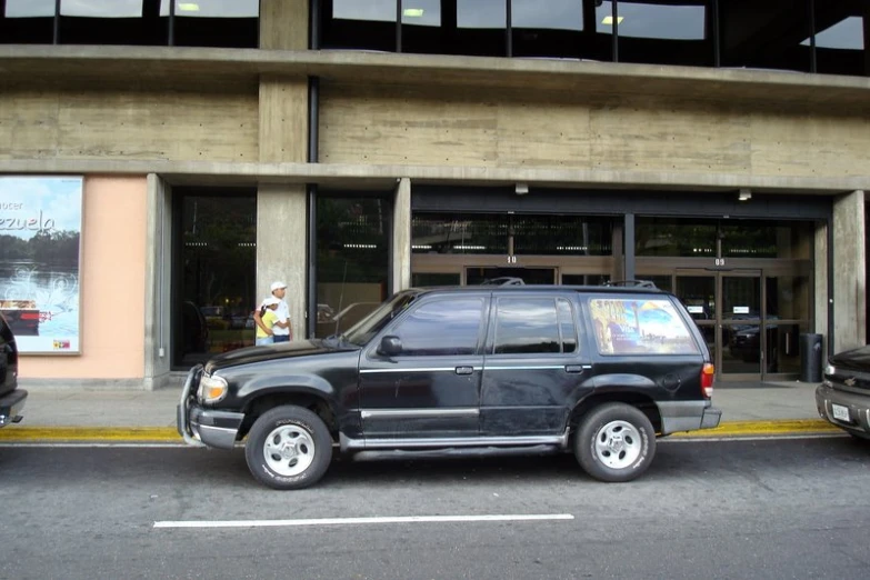 the jeep is parked in front of a building