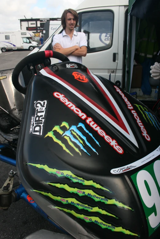 a woman leaning on the side of a vehicle