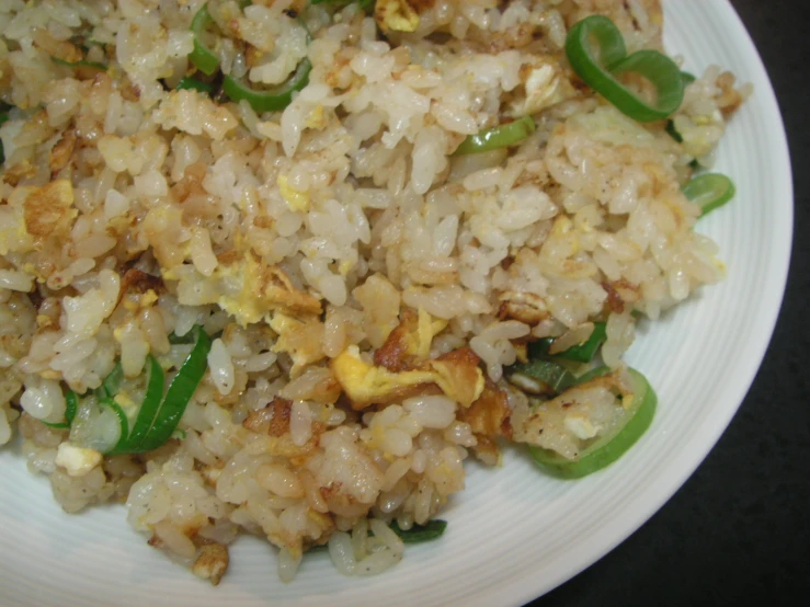 some rice and meat with green peppers and peppers