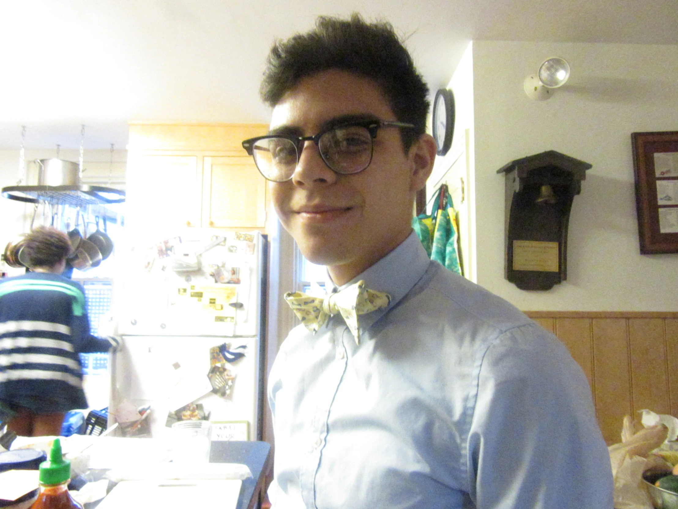 the young man is wearing glasses and a bow tie