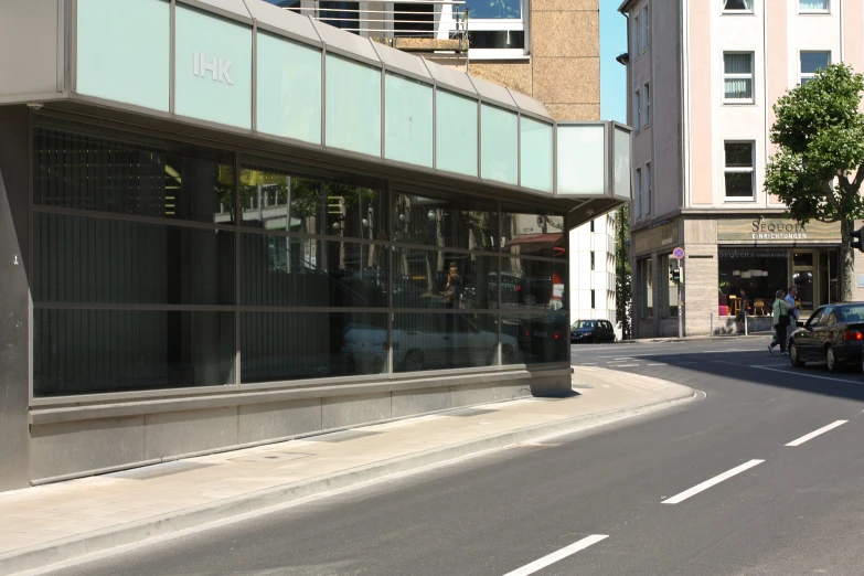 a car parked next to a city street with tall buildings