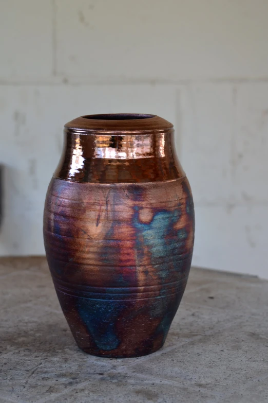 a vase sitting on a table in a white room