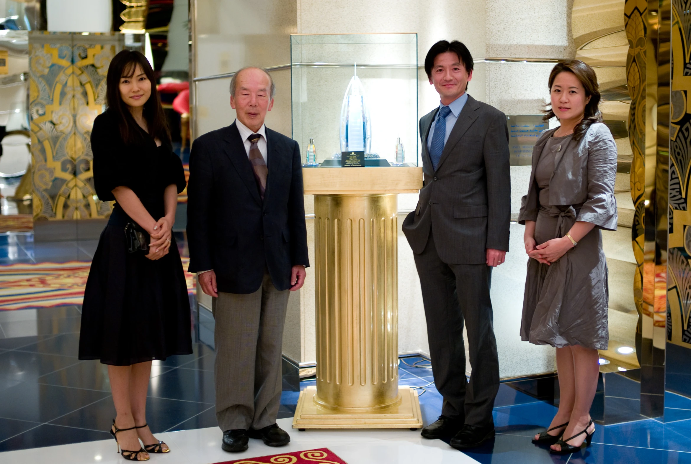 a group of people standing next to each other in front of a monument