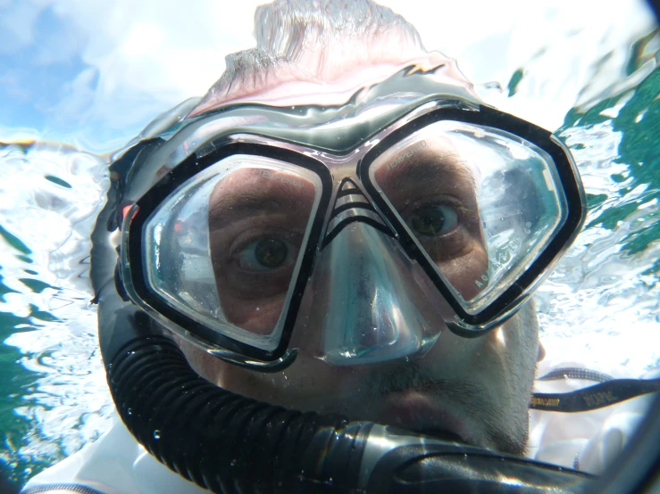 a man is diving for a picture under the water