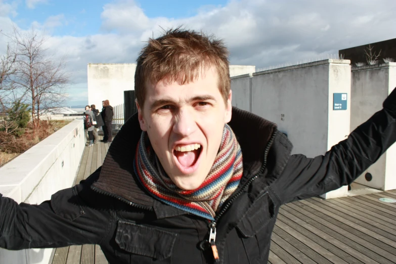 a young man is opening his mouth and making a strange face