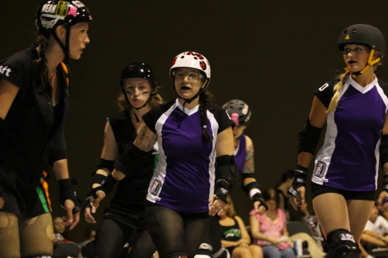 a bunch of women on roller skates standing next to each other