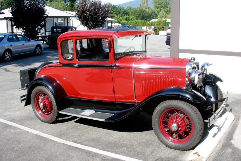 an old, red - and - black ford truck is parked in a parking lot