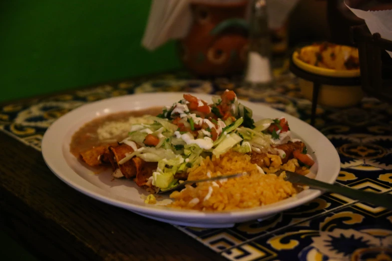 a white plate with vegetables and rice on it