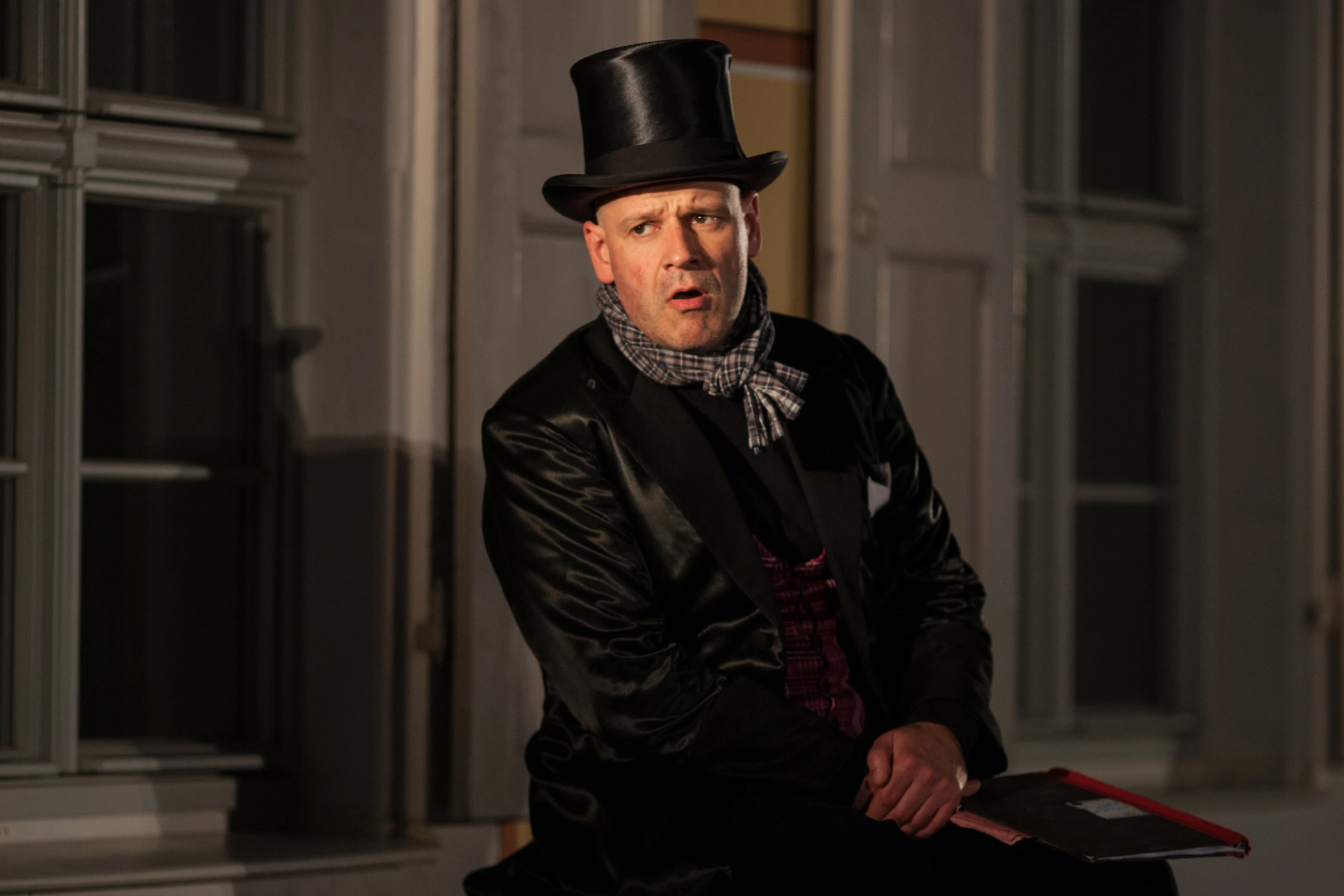 a man in a top hat sitting on top of a table