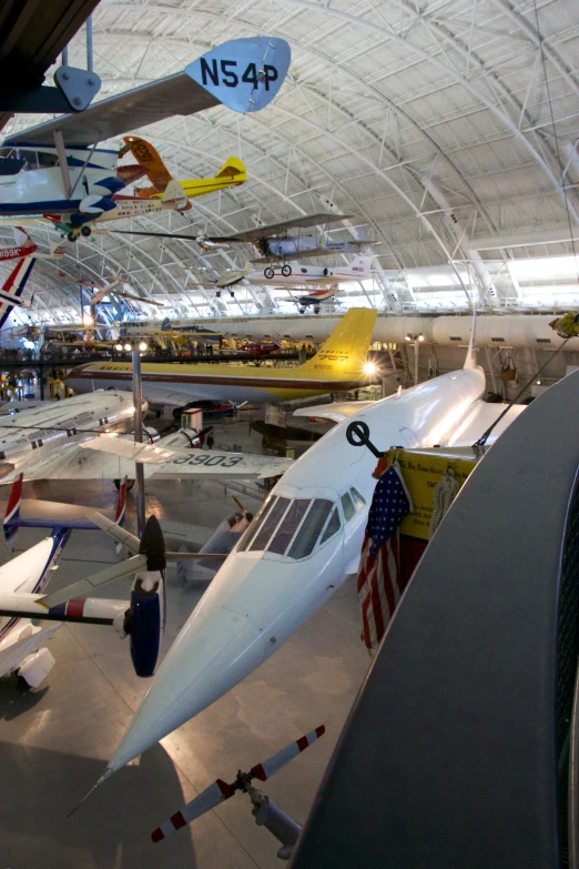 airplanes lined up and hanging on the walls inside a building