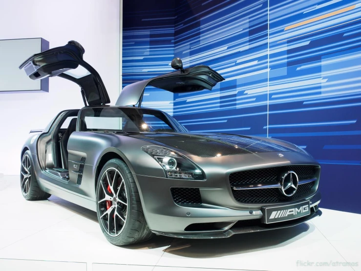 a mercedes sls convertible parked in front of a blue wall