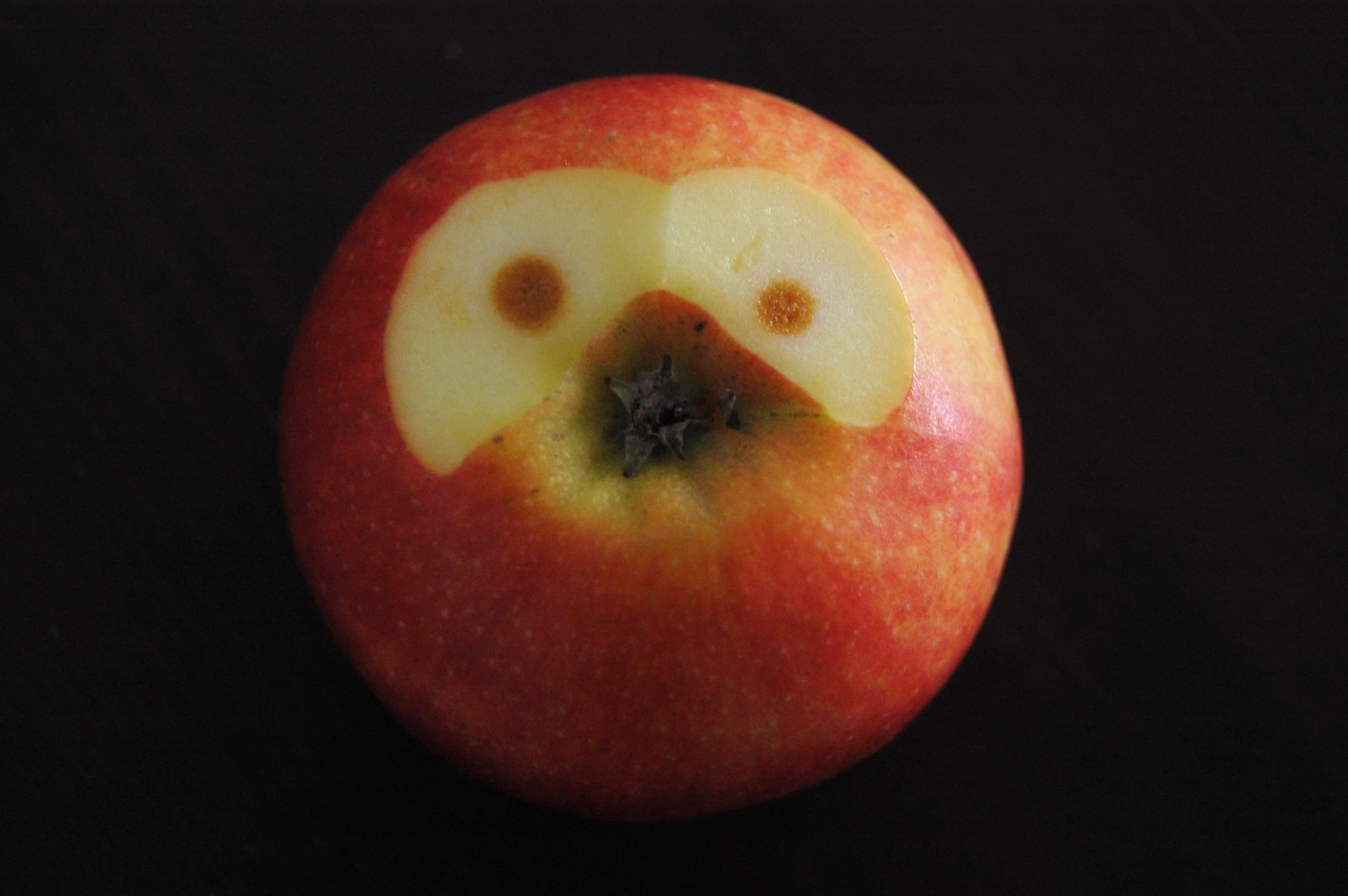 an apple with some holes cut into it